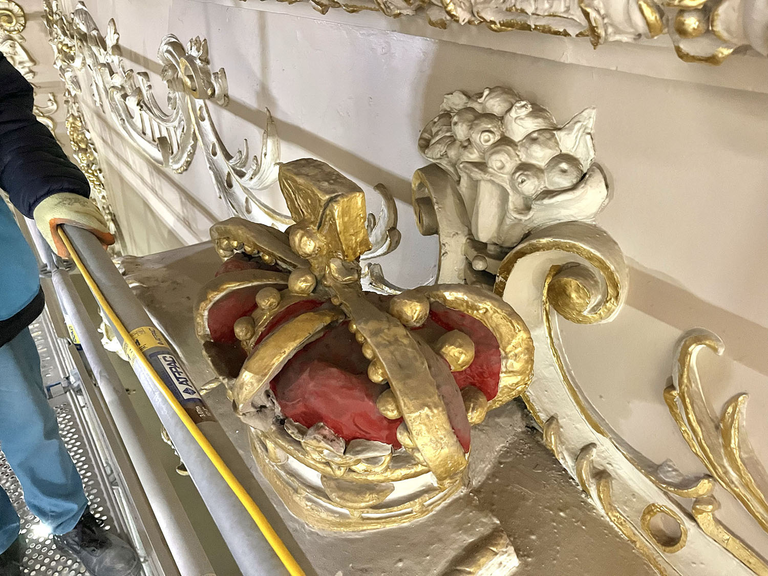 The central plaster crown as seen from the temporary dancefloor. The crown holds the central position within the auditorium, being mounted above the centre of the proscenium arch.