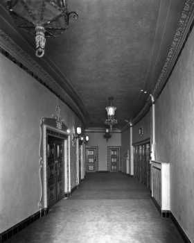 Corridor behind the rear Stalls (main floor) seating as photographed in 1930, with fire exits to the exterior on the right side, from the <i>Royal Institute of British Architects Collections</i> (JPG)